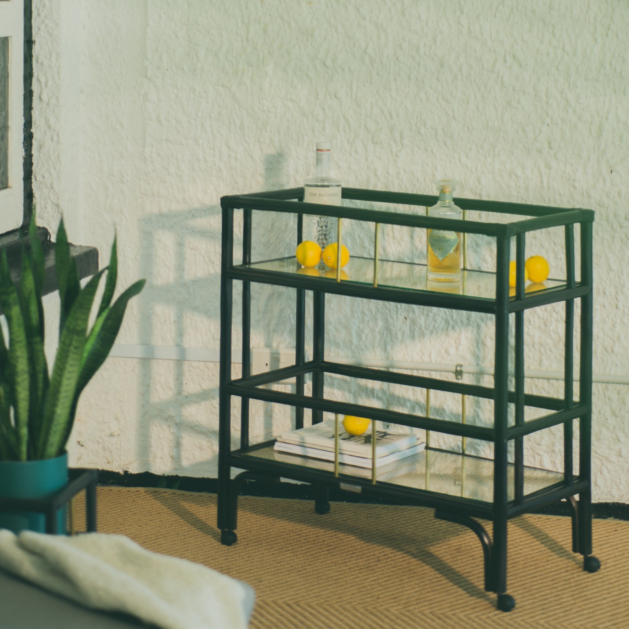 Elegant black rattan bar cart designed in Singapore, showcasing a minimalist aesthetic. Features two spacious tiers perfect for serving, storage, or styling in modern and functional living spaces.