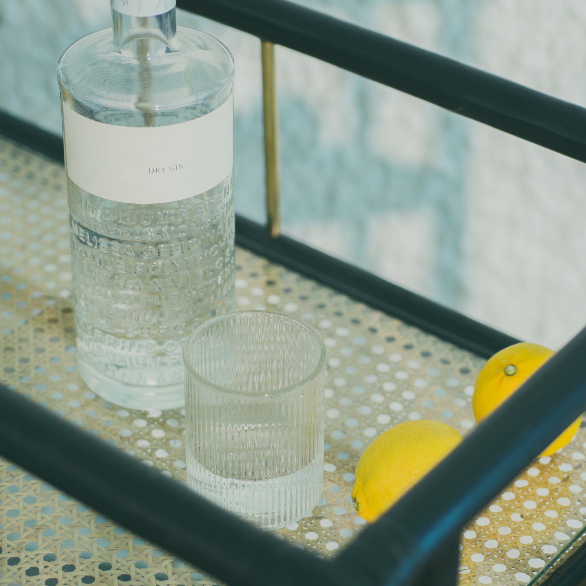 Elegant black rattan bar cart designed in Singapore, showcasing a minimalist aesthetic. Features two spacious tiers perfect for serving, storage, or styling in modern and functional living spaces.