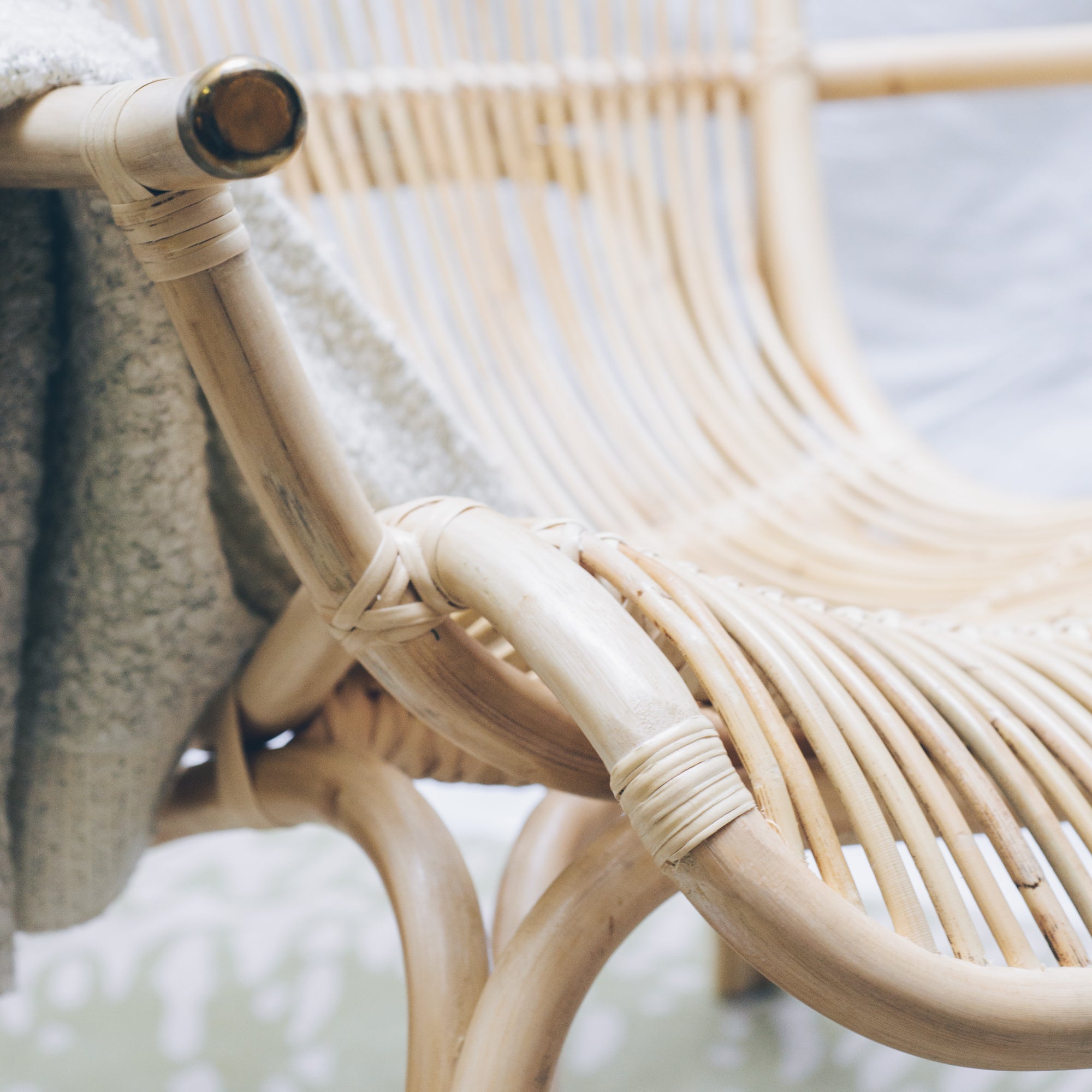 Close-up on the natural rattan of the handcrafted LEANNE Cane Chair, a nostalgic piece that brings timeless charm to any space. Designed in Singapore, it showcases artisanal craftsmanship with an airy frame and warm textures, perfect for relaxed living.