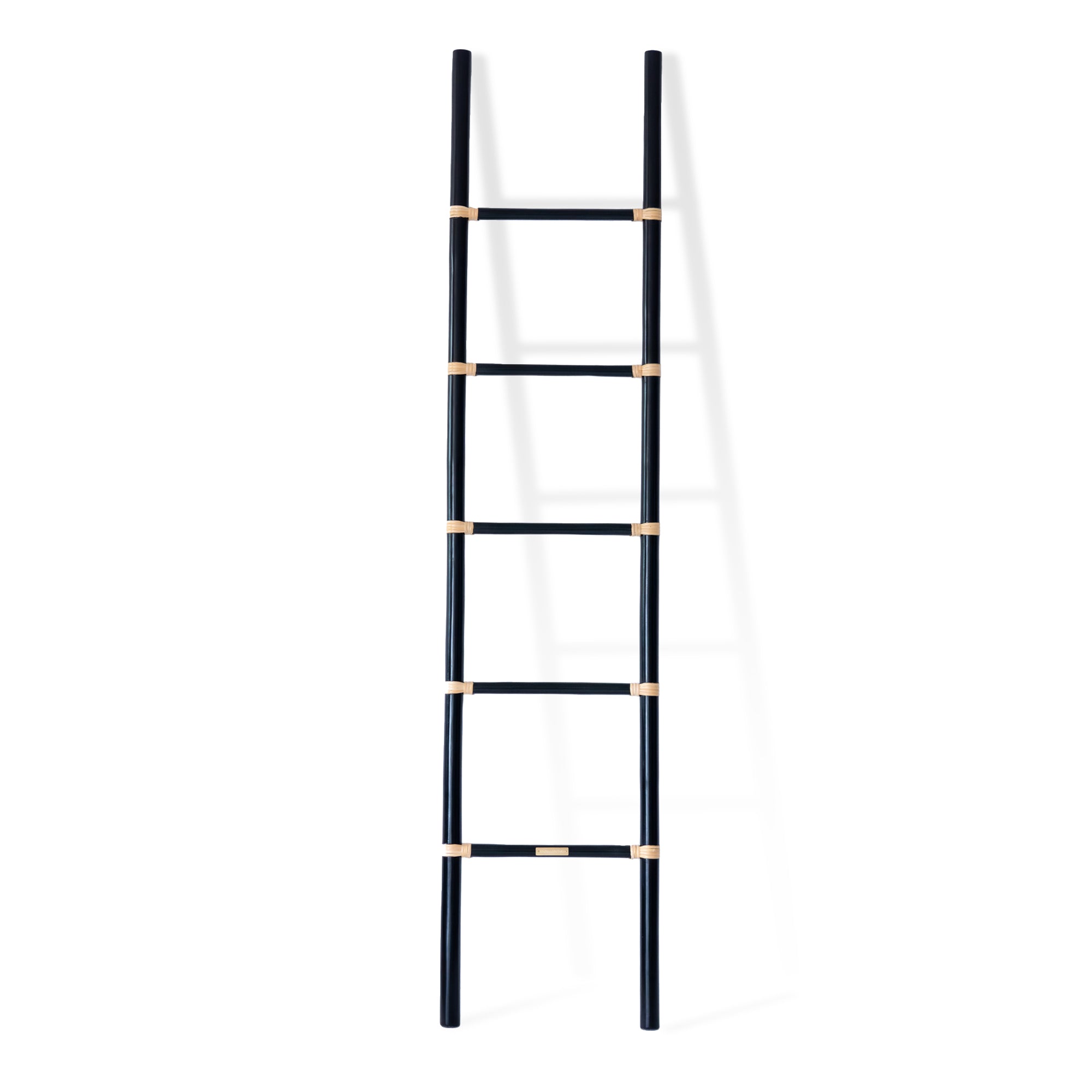 Designed in Singapore, this handcrafted black cane ladder showcases the beauty of rattan with a modern touch. Its sleek silhouette makes it a stylish, functional accent for any space, perfect for displaying throws, magazines, or decor with effortless charm. One of Nature Native's best-loved pieces.
