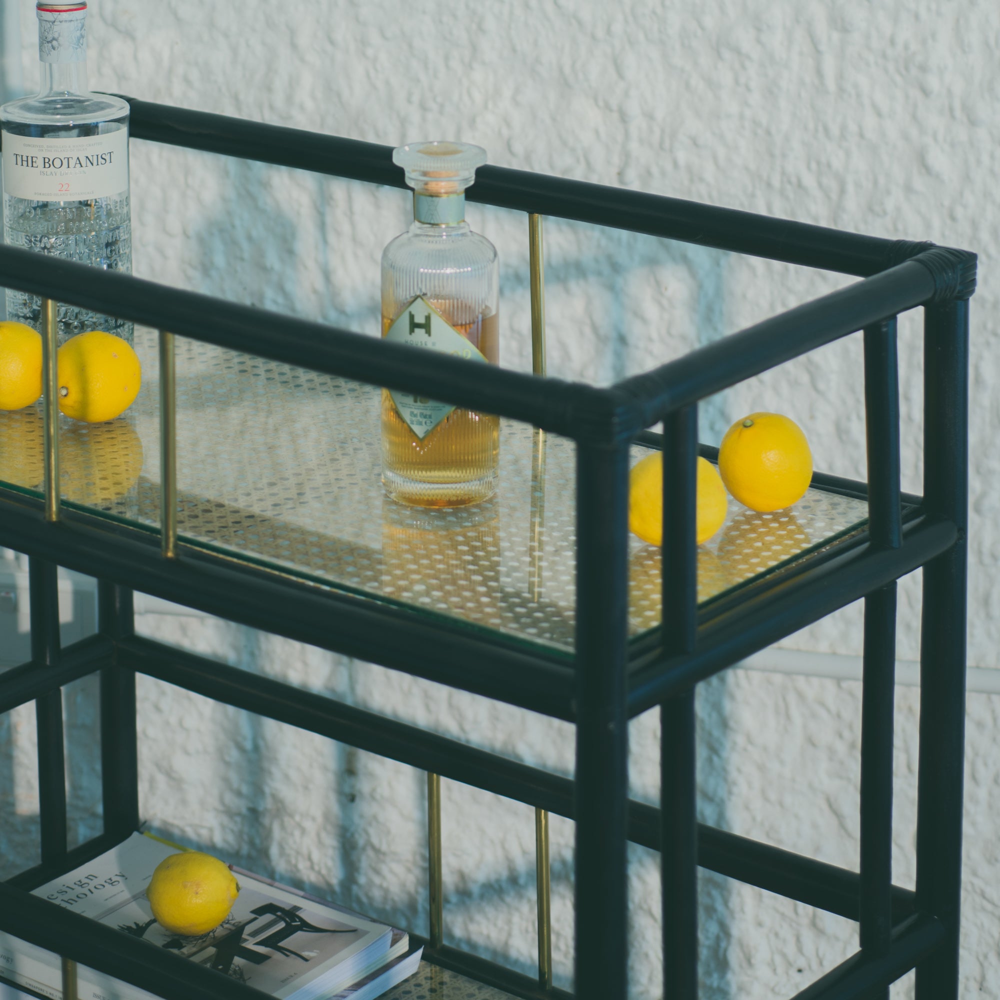 Elegant black rattan bar cart designed in Singapore, showcasing a minimalist aesthetic. Features two spacious tiers perfect for serving, storage, or styling in modern and functional living spaces.