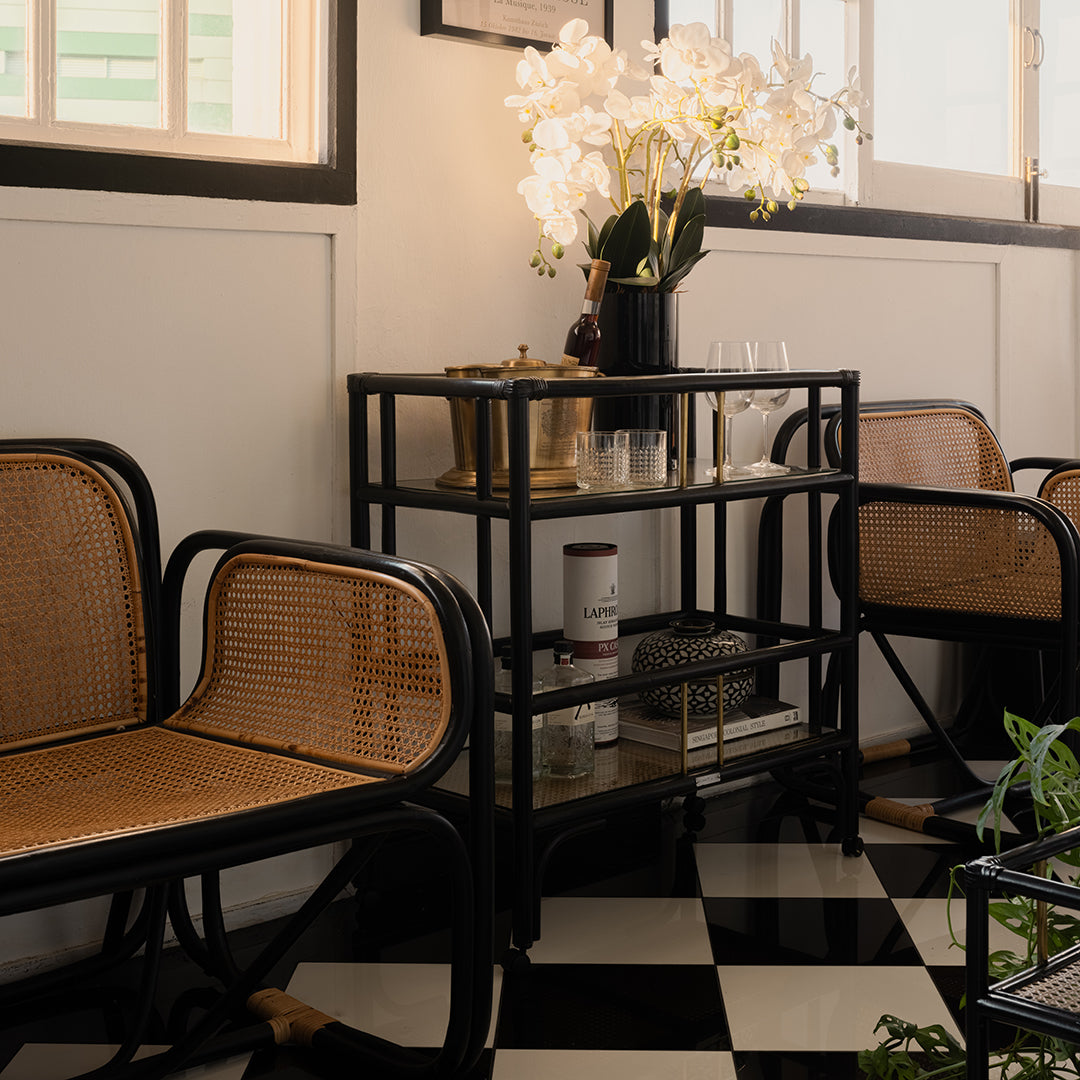 Elegant black rattan bar cart designed in Singapore, showcasing a minimalist aesthetic. Features two spacious tiers perfect for serving, storage, or styling in modern and functional living spaces.