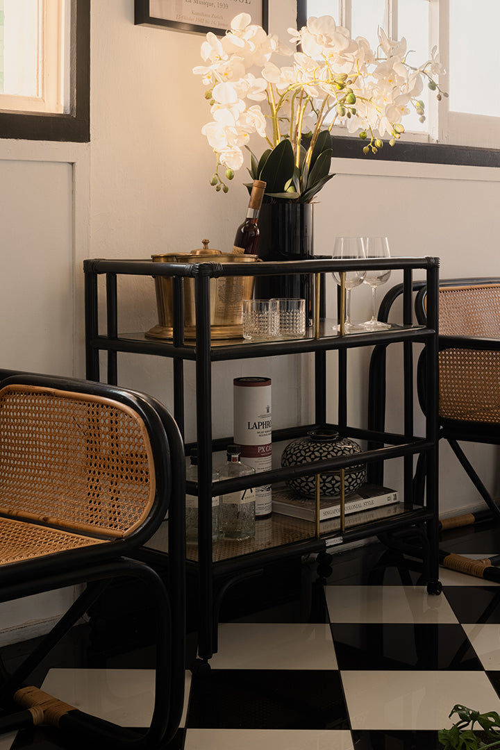 Elegant black rattan bar cart designed in Singapore, showcasing a minimalist aesthetic. Features two spacious tiers perfect for serving, storage, or styling in modern and functional living spaces.