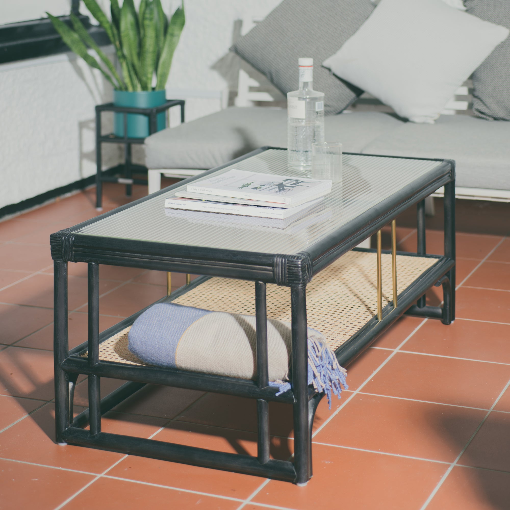 Stylish black rattan coffee table featuring a durable design with natural textures. Perfect for adding a touch of sophistication and warmth to any living space. Designed in Singapore, combining modern aesthetics with natural elements.