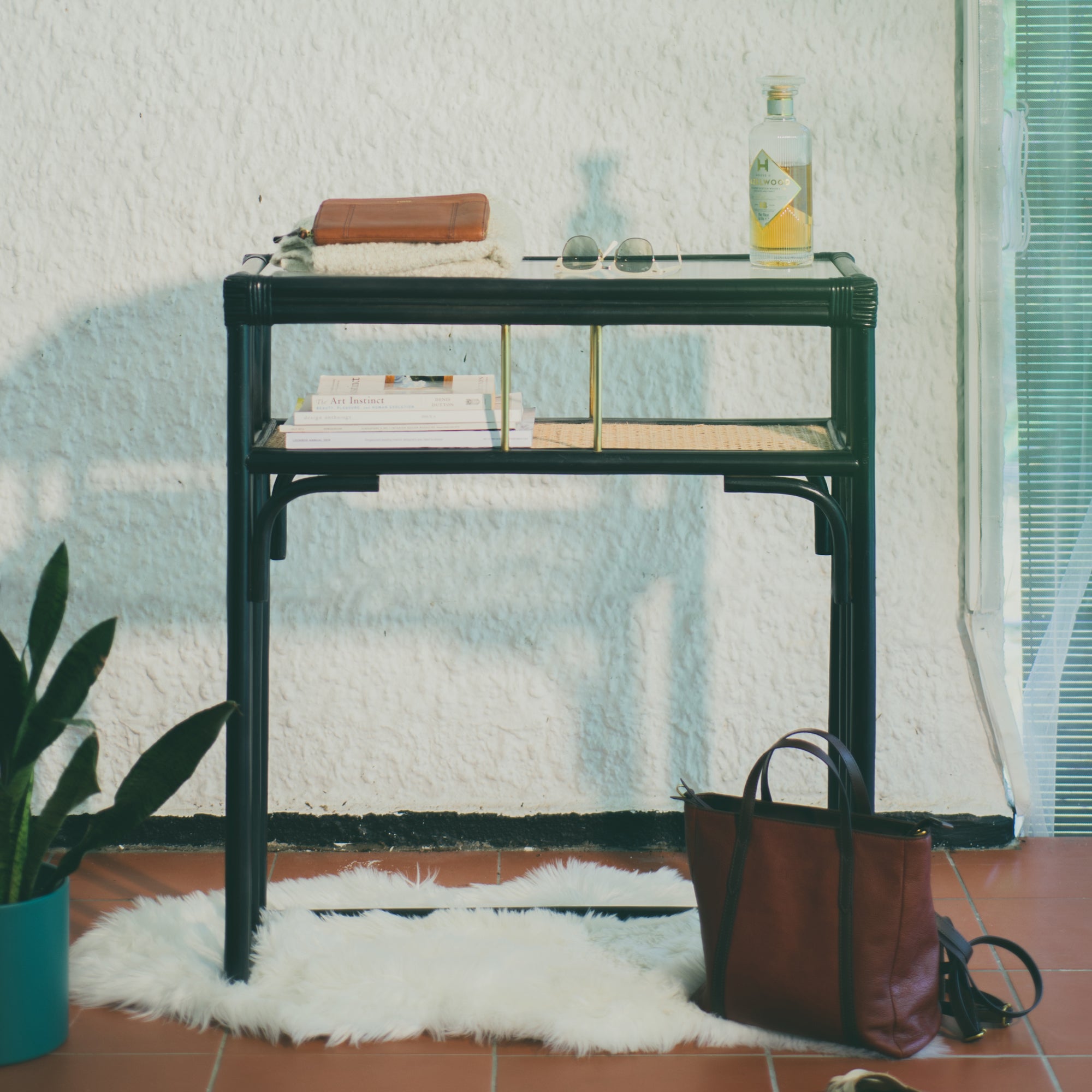 Minimalist black rattan console table with a sleek design and sturdy construction, perfect for adding functional elegance to any entryway or living space. Designed in Singapore, it features a balanced combination of form and function, offering ample surface space while maintaining a lightweight, airy aesthetic.
