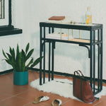Minimalist black rattan console table with a sleek design and sturdy construction, perfect for adding functional elegance to any entryway or living space. Designed in Singapore, it features a balanced combination of form and function, offering ample surface space while maintaining a lightweight, airy aesthetic.