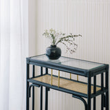 Minimalist black rattan console table with a sleek design and sturdy construction, perfect for adding functional elegance to any entryway or living space. Designed in Singapore, it features a balanced combination of form and function, offering ample surface space while maintaining a lightweight, airy aesthetic.