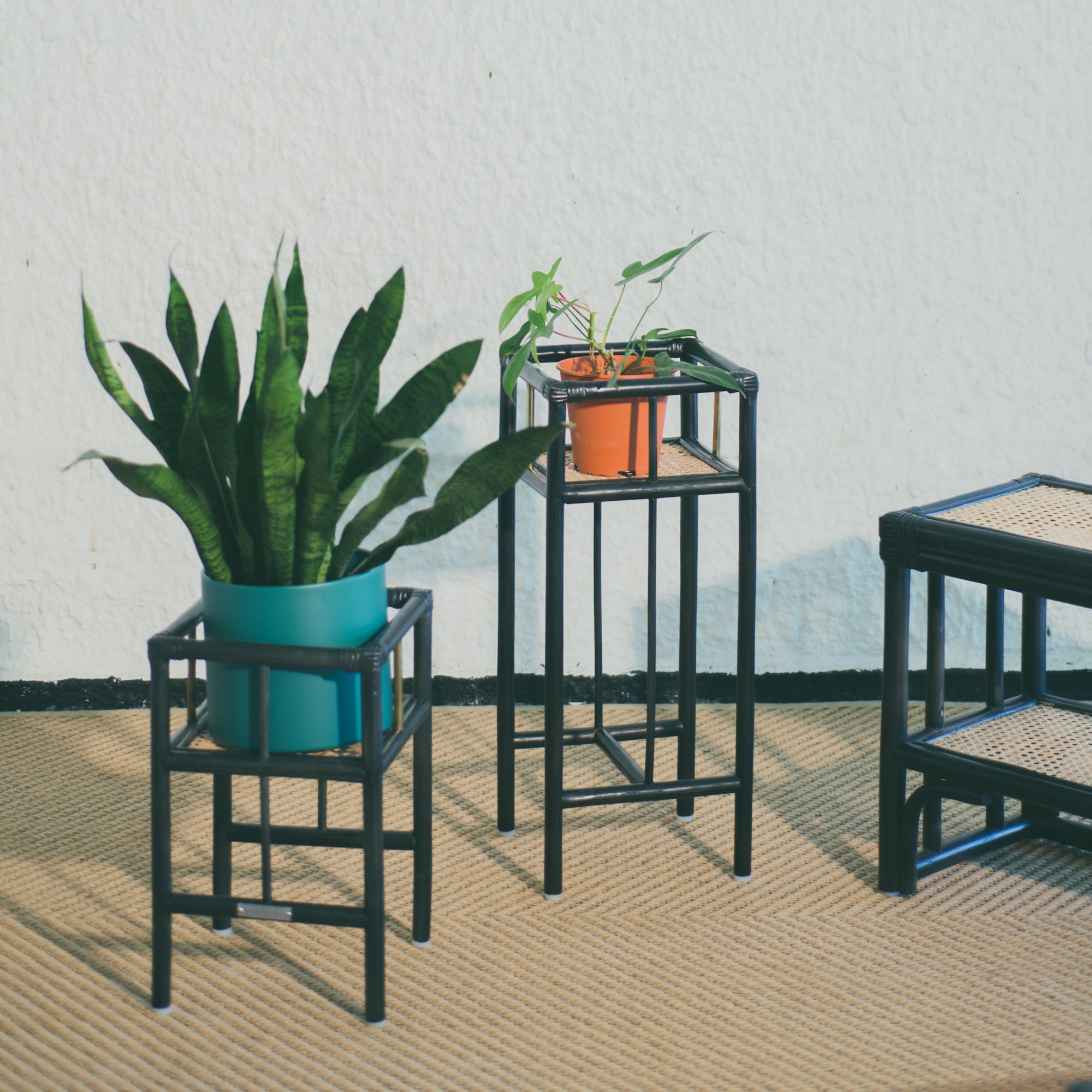 Modern black rattan planter featuring a sturdy frame and natural texture, perfect for housing your favorite plants. Designed with simplicity in mind, it adds a touch of warmth and elegance to any space. Created with eco-friendly materials, this piece blends sustainability with style. Designed in Singapore.
