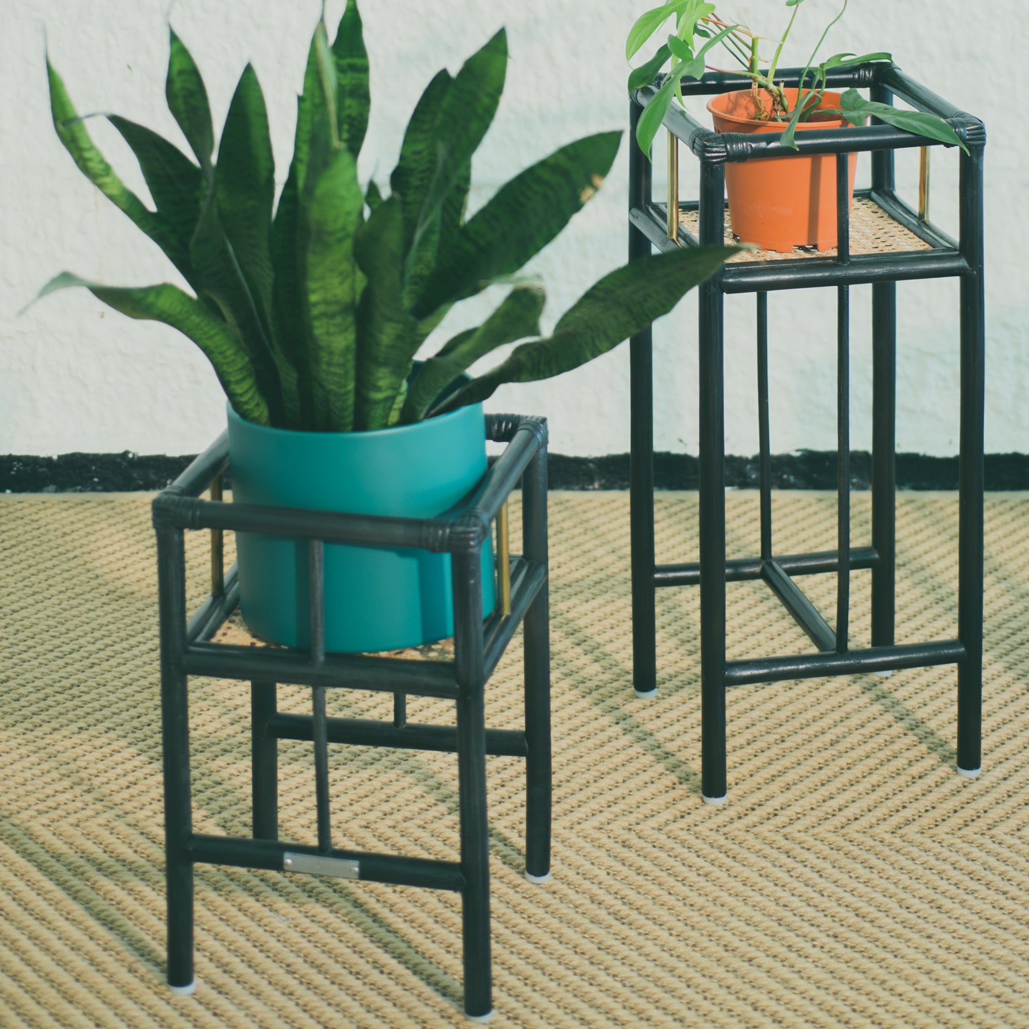 Modern black rattan planter featuring a sturdy frame and natural texture, perfect for housing your favorite plants. Designed with simplicity in mind, it adds a touch of warmth and elegance to any space. Created with eco-friendly materials, this piece blends sustainability with style. Designed in Singapore.