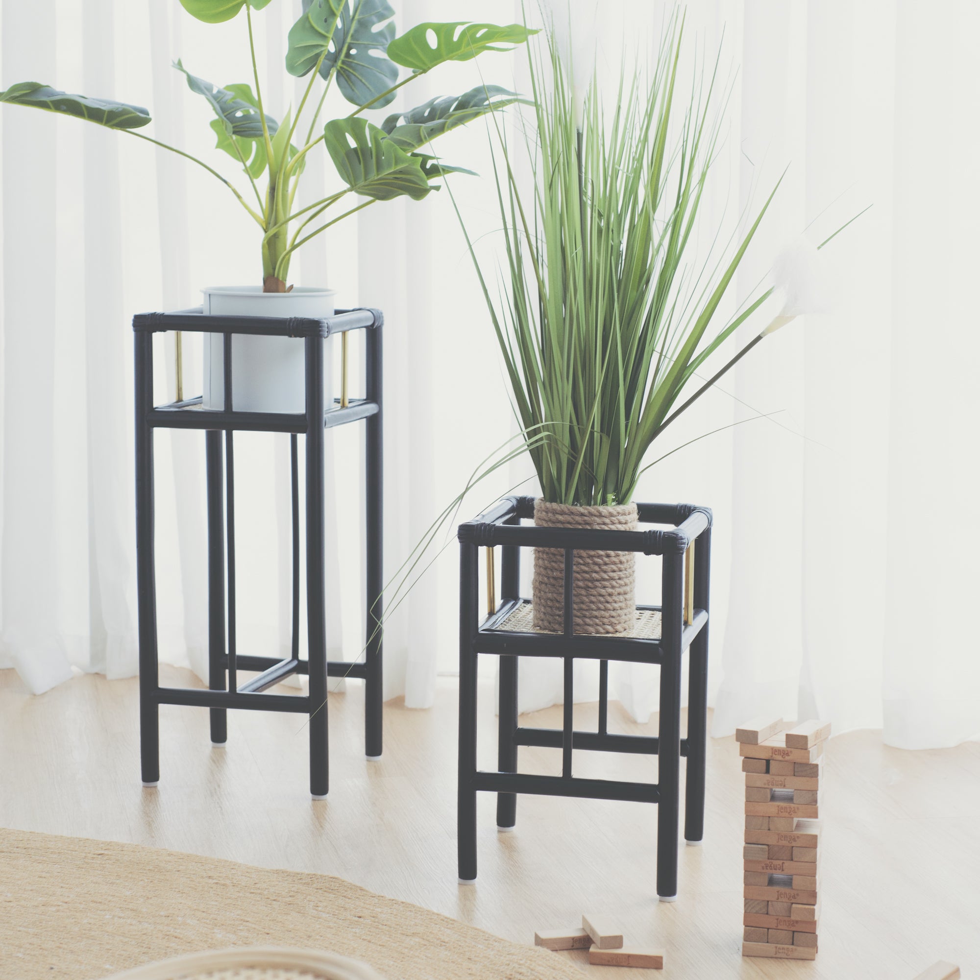 Modern black rattan planter featuring a sturdy frame and natural texture, perfect for housing your favorite plants. Designed with simplicity in mind, it adds a touch of warmth and elegance to any space. Created with eco-friendly materials, this piece blends sustainability with style. Designed in Singapore.