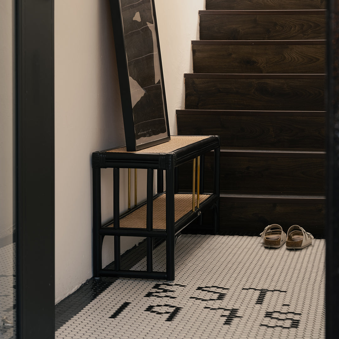 Black rattan shoe bench with an open-concept, double-layer design, offering ample storage for shoes and more. Designed in Singapore, it seamlessly blends natural elegance with functionality, perfect for modern entryways.