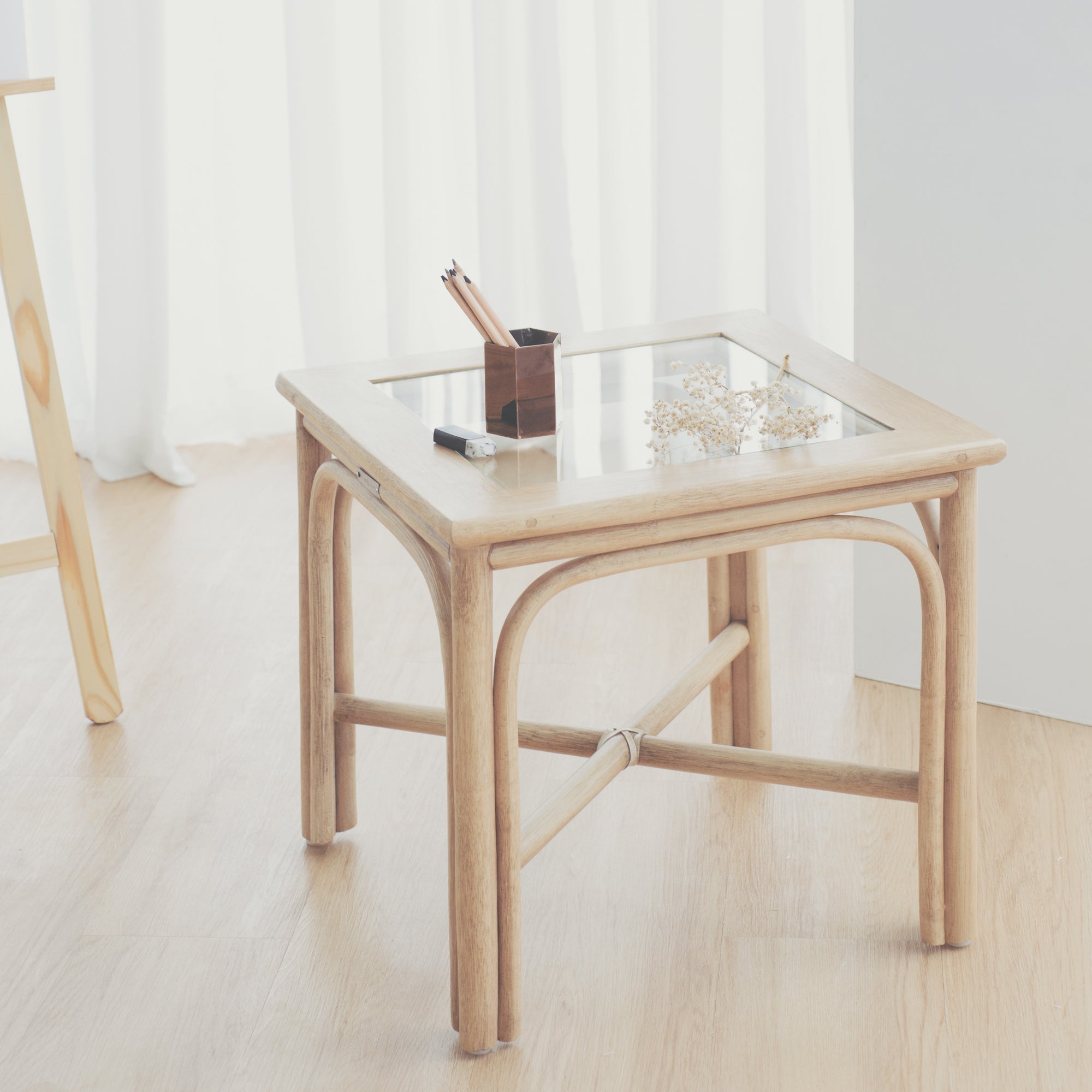 A handcrafted cane side table with tempered glass surface. A perfect blend of elegance and functionality, it adds warmth to any space while showcasing artisanal craftsmanship.
