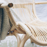 Close-up on the natural rattan of the handcrafted LEANNE Cane Chair, a nostalgic piece that brings timeless charm to any space. Designed in Singapore, it showcases artisanal craftsmanship with an airy frame and warm textures, perfect for relaxed living.