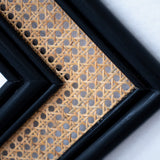 Black rattan mirror with a handcrafted frame, combining natural texture and modern design. Its sleek finish and minimalist aesthetic make it a versatile statement piece for any room. Designed in Singapore, it reflects timeless elegance with a touch of heritage charm.