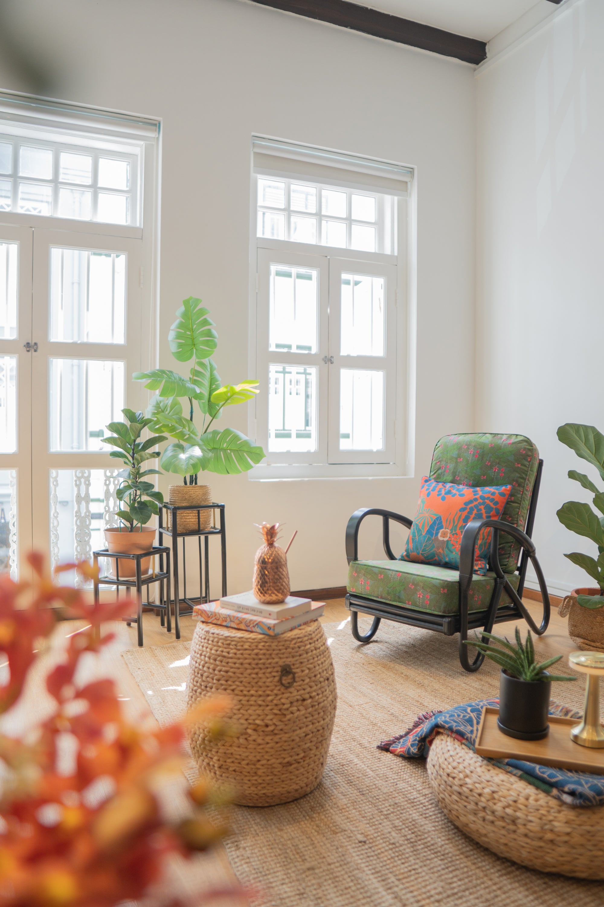 A Singapore light-filled shophouse in Chinatown with contemporary design handcrafted cane and rattan furniture in black and natural colours with local design prints